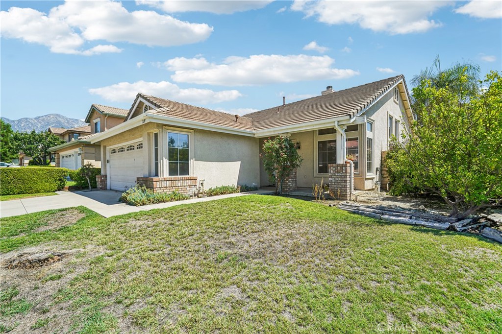 7271 Venosa Place Rancho Cucamonga, CA 91701 - Photo 3 of 32 a front view of house with yard and green space