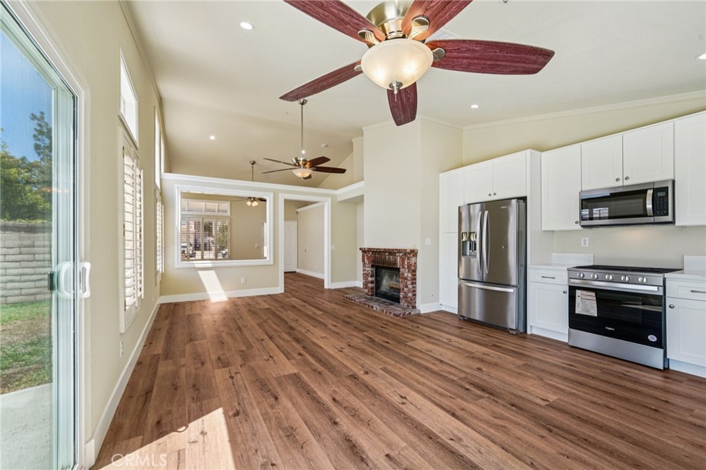7271 Venosa Place Rancho Cucamonga, CA 91701 - Photo 8 of 32 a view of a kitchen with a stove cabinets and wooden floor