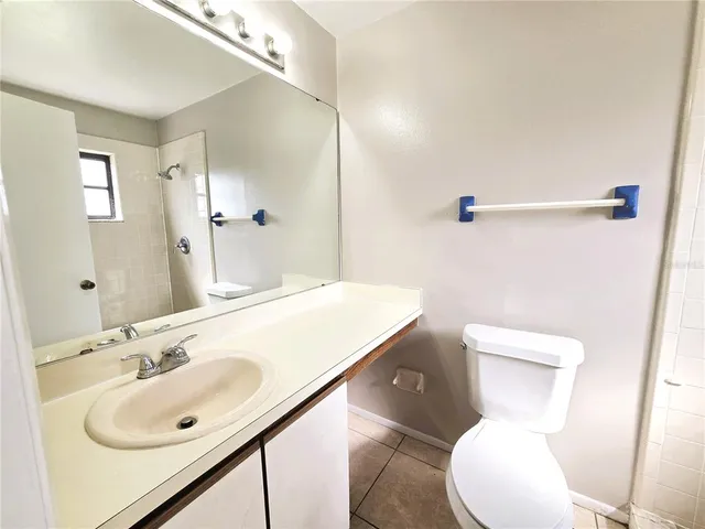 a bathroom with a sink a toilet and mirror