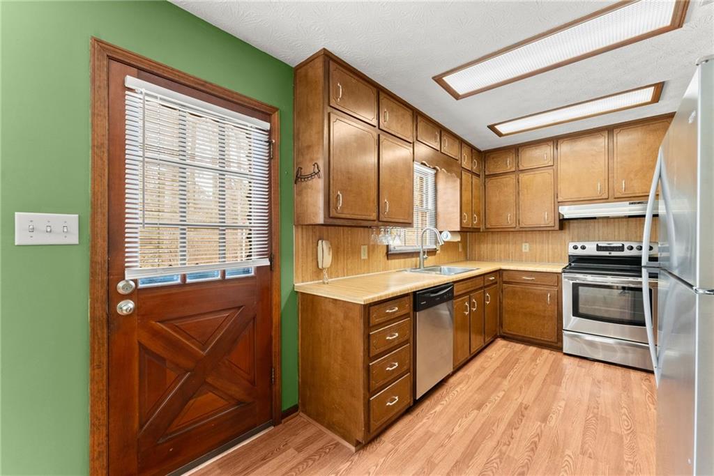 4691 Lucerne Valley Road Southwest Lilburn, GA 30047 - Photo 13 of 55 a kitchen with a stove sink and cabinets