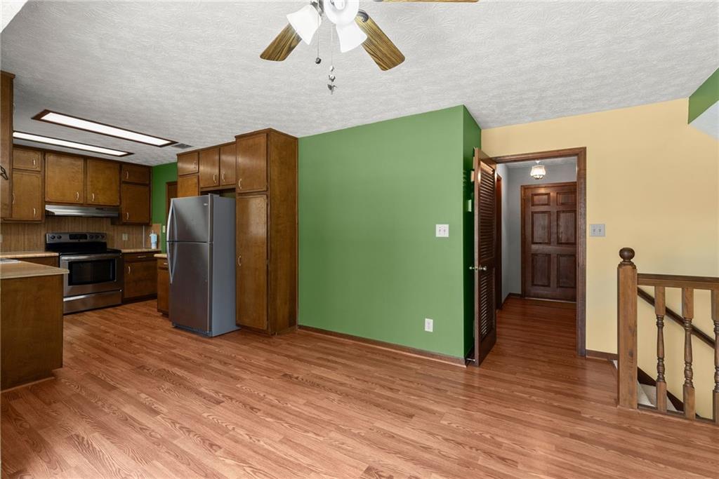4691 Lucerne Valley Road Southwest Lilburn, GA 30047 - Photo 16 of 55 a kitchen with stainless steel appliances granite countertop a refrigerator a stove and a sink