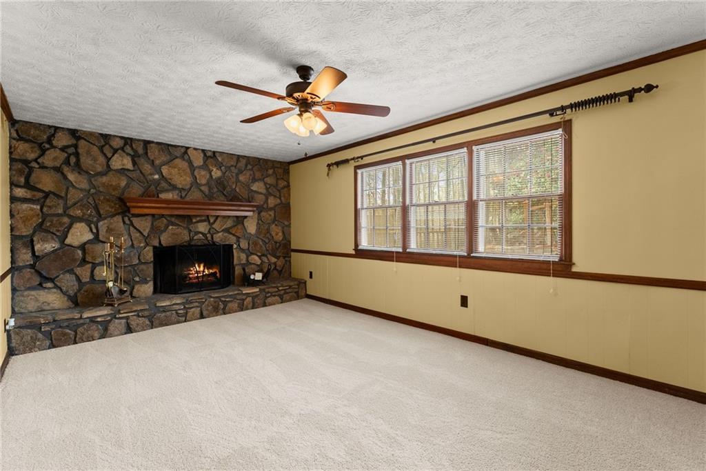 4691 Lucerne Valley Road Southwest Lilburn, GA 30047 - Photo 17 of 55 a view of an empty room with a fireplace and a window