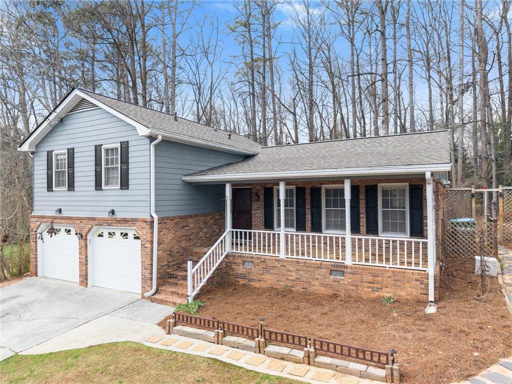 4691 Lucerne Valley Road Southwest Lilburn, GA 30047 - Photo 2 of 55 a view of a house with a yard and large tree