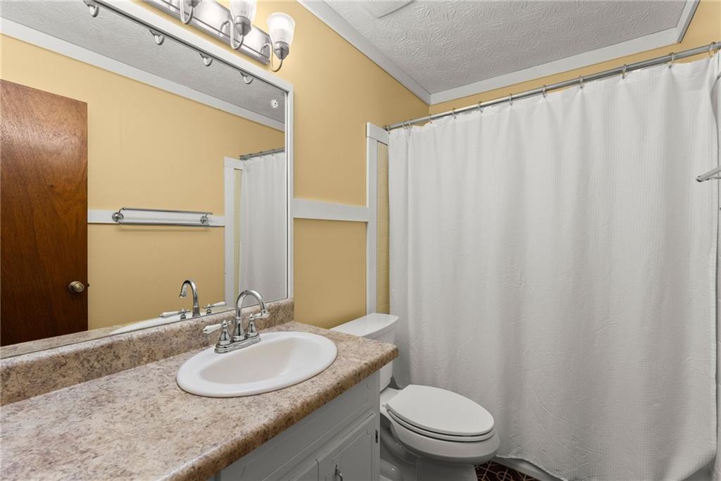 4691 Lucerne Valley Road Southwest Lilburn, GA 30047 - Photo 21 of 55 a bathroom with a granite countertop sink and a mirror