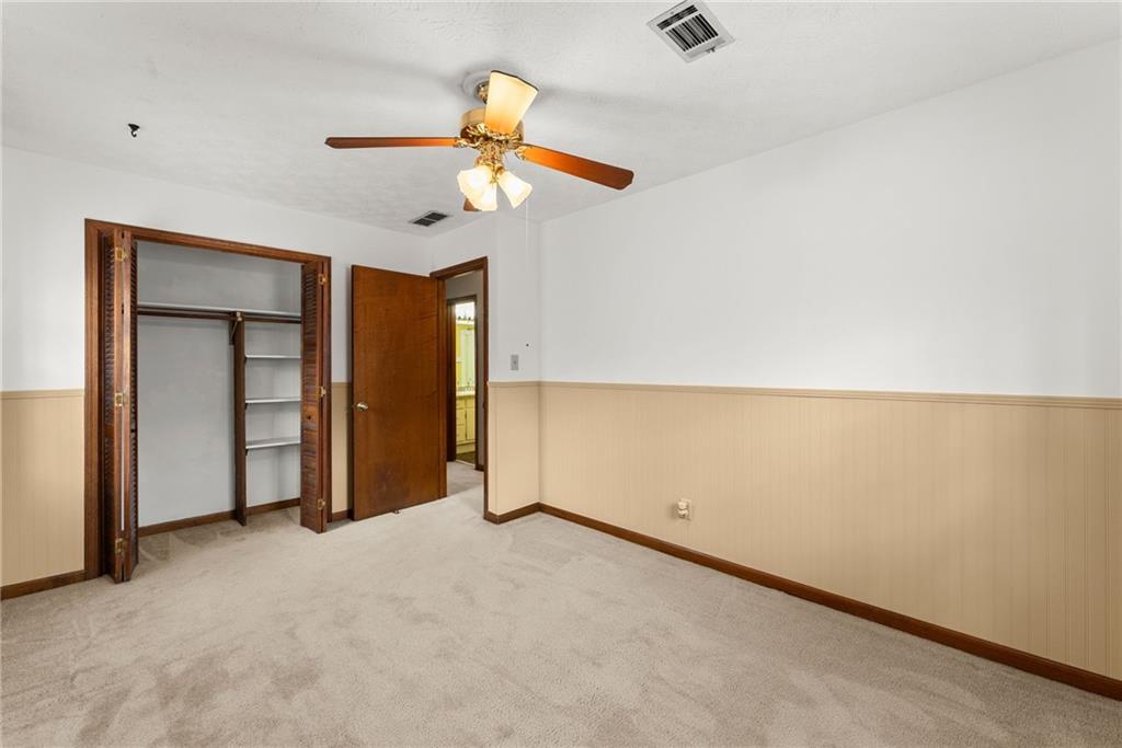 4691 Lucerne Valley Road Southwest Lilburn, GA 30047 - Photo 29 of 55 an empty room with a ceiling fan and a window