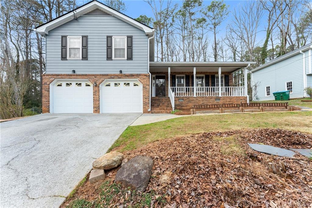 4691 Lucerne Valley Road Southwest Lilburn, GA 30047 - Photo 3 of 55 a front view of a house with a yard