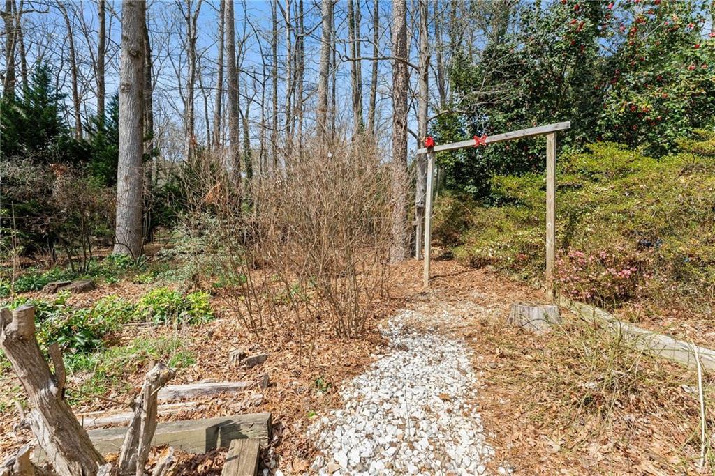4691 Lucerne Valley Road Southwest Lilburn, GA 30047 - Photo 35 of 55 a backyard of a house with lots of green space