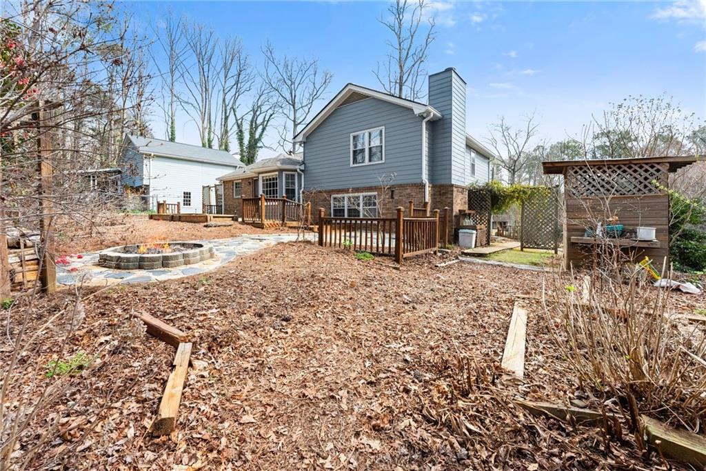 4691 Lucerne Valley Road Southwest Lilburn, GA 30047 - Photo 40 of 55 a view of a house with a yard and wooden fence