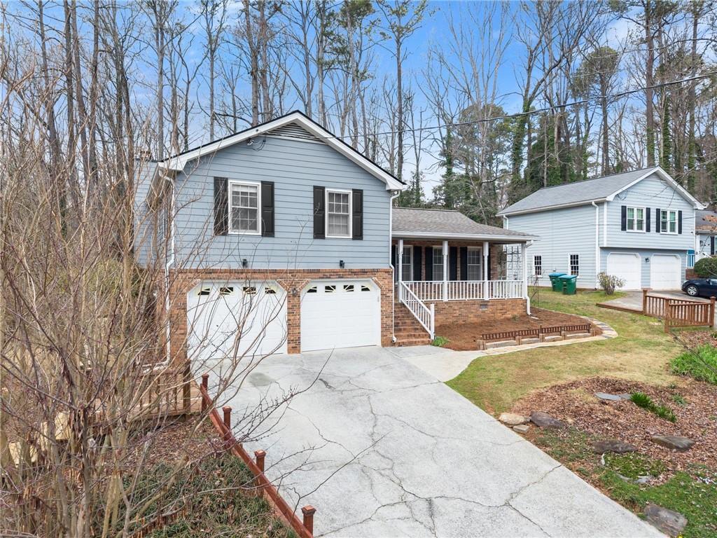 4691 Lucerne Valley Road Southwest Lilburn, GA 30047 - Photo 4 of 55 a front view of a house with a yard and garage
