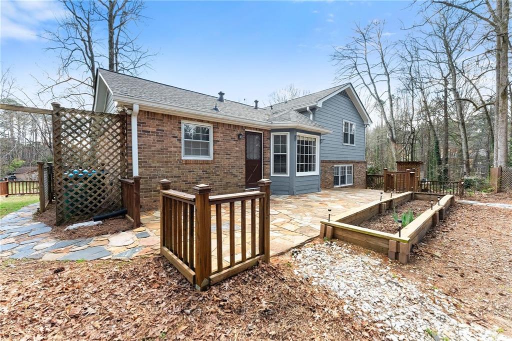 4691 Lucerne Valley Road Southwest Lilburn, GA 30047 - Photo 42 of 55 a view of a house with wooden fence and a yard