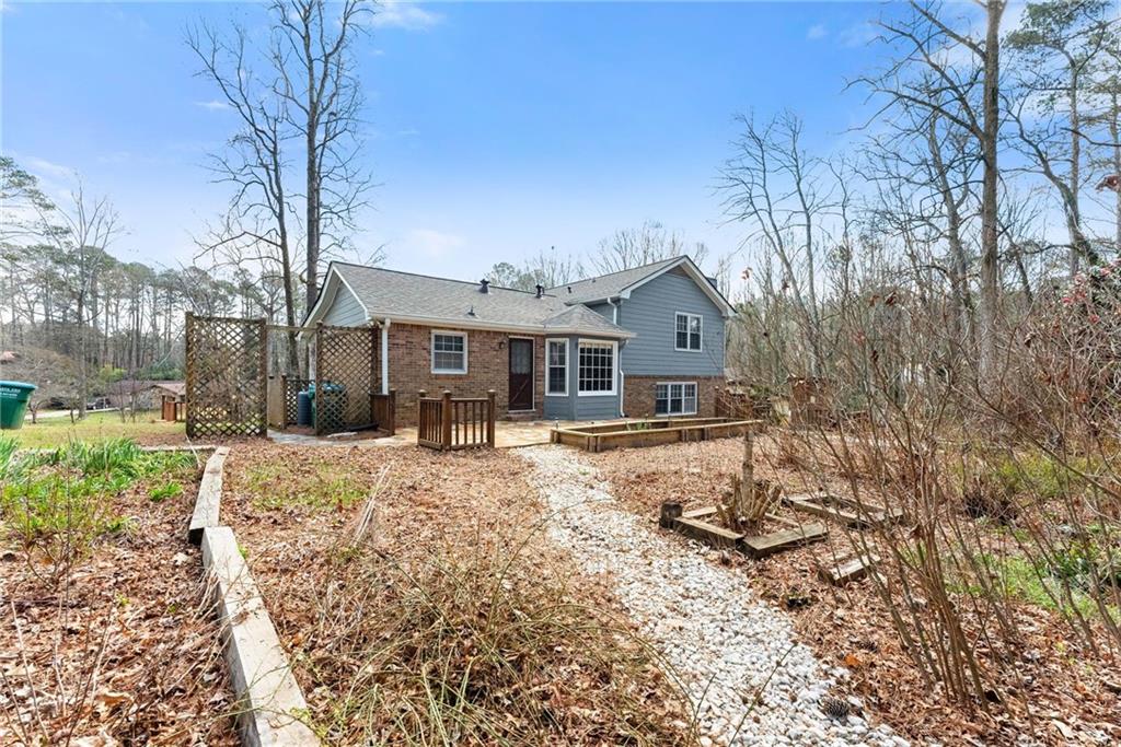 4691 Lucerne Valley Road Southwest Lilburn, GA 30047 - Photo 43 of 55 a front view of a house with a yard covered in snow