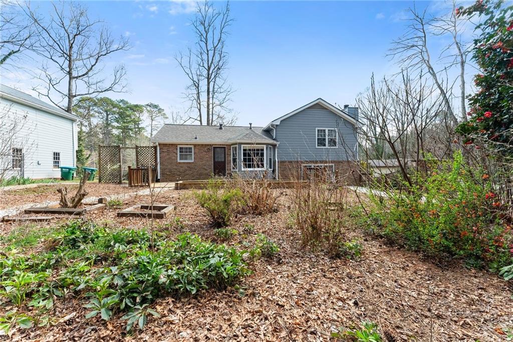 4691 Lucerne Valley Road Southwest Lilburn, GA 30047 - Photo 44 of 55 a front view of a house with garden