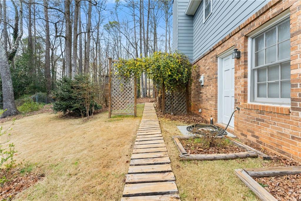 4691 Lucerne Valley Road Southwest Lilburn, GA 30047 - Photo 47 of 55 a front view of a house with a yard