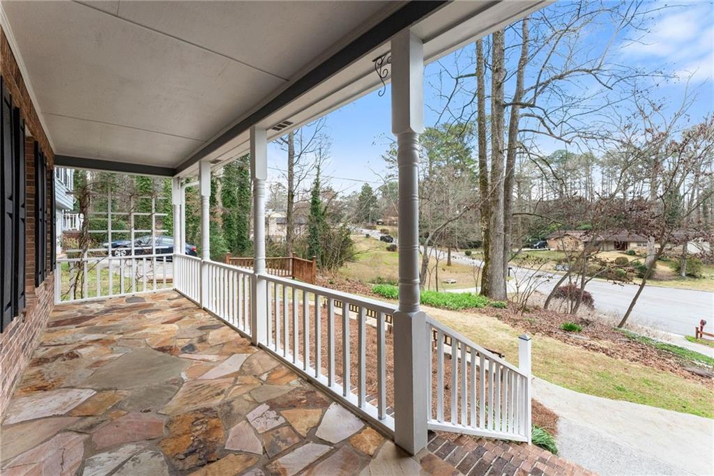 4691 Lucerne Valley Road Southwest Lilburn, GA 30047 - Photo 7 of 55 a view of a porch with wooden floor and fence