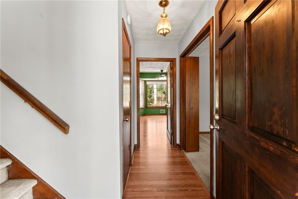 4691 Lucerne Valley Road Southwest Lilburn, GA 30047 - Photo 8 of 55 a view of a hallway with wooden floor and staircase
