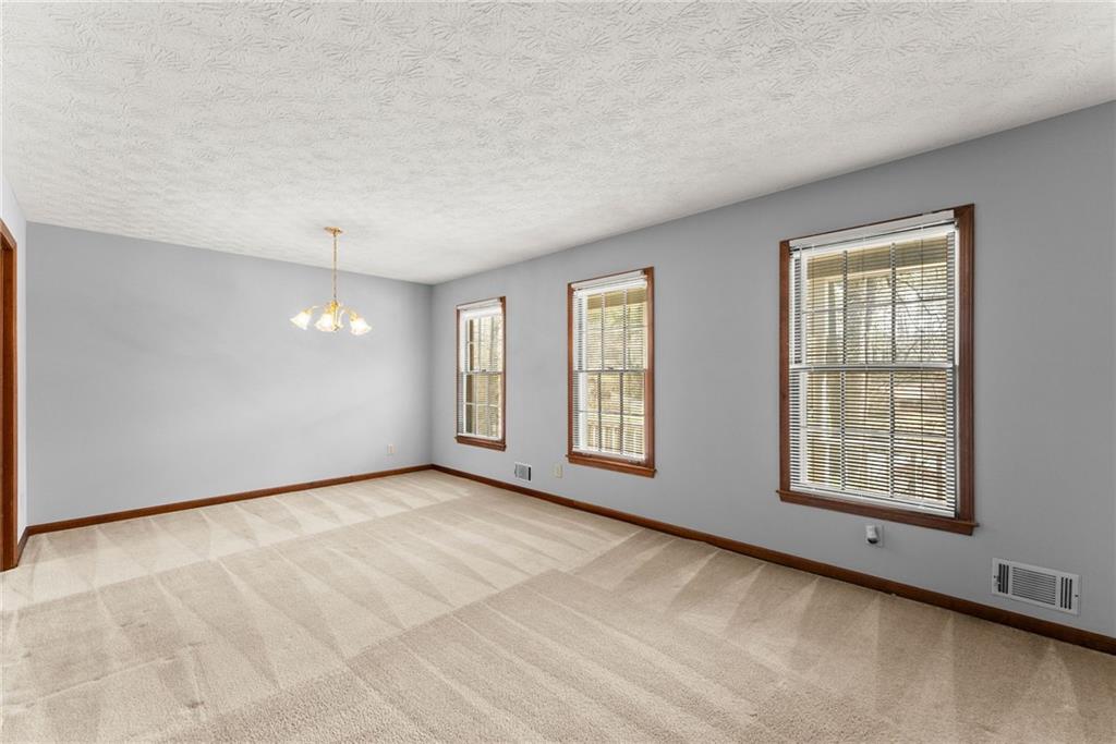 4691 Lucerne Valley Road Southwest Lilburn, GA 30047 - Photo 9 of 55 an empty room with windows