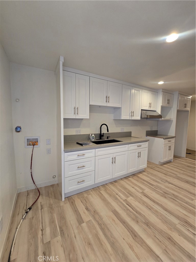 3374 1/2 Fashion Avenue Long Beach, CA 90810 - Photo 3 of 11 a kitchen with white cabinets and appliances