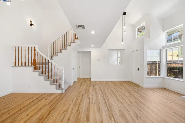 a view of a hallway with wooden floor and entryway