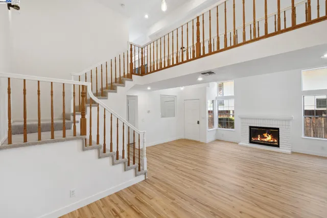 a view of main area with wooden floor and a fireplace