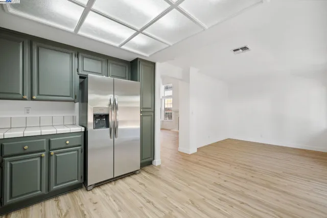 a kitchen with stainless steel appliances a refrigerator and a sink