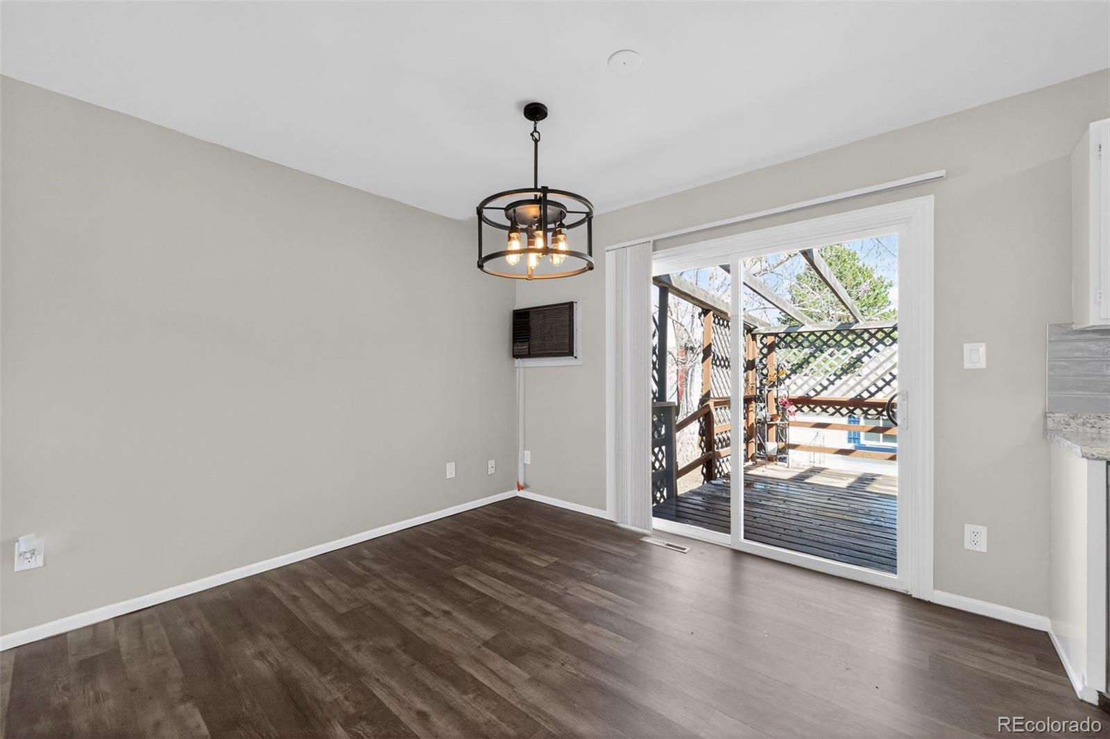2116 Springfield Court Fort Collins, CO 80521 - Photo 16 of 29 a view of an empty room with wooden floor and a window