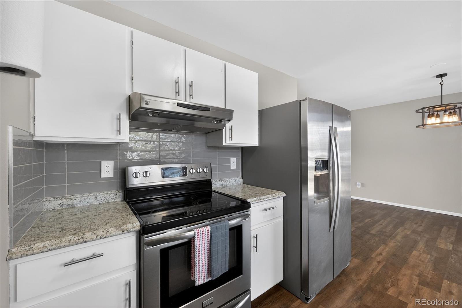 2116 Springfield Court Fort Collins, CO 80521 - Photo 19 of 29 a kitchen with stainless steel appliances granite countertop a stove and a refrigerator