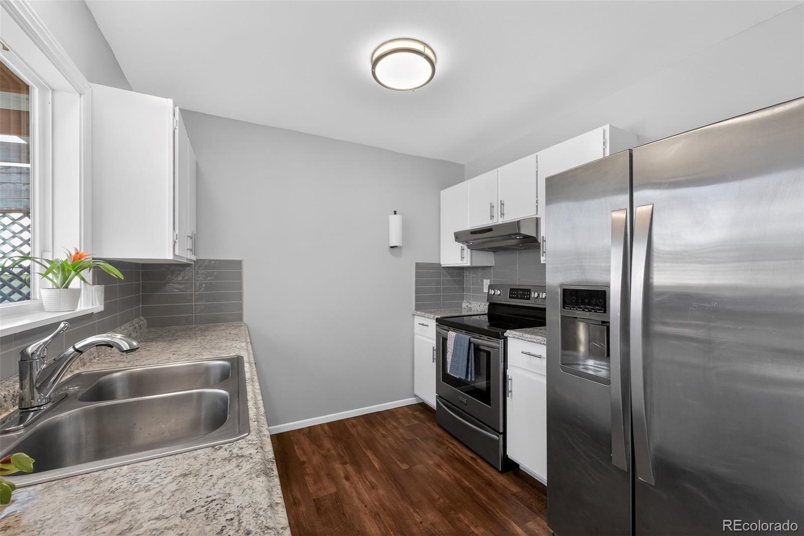 2116 Springfield Court Fort Collins, CO 80521 - Photo 20 of 29 a kitchen with a refrigerator sink and stove