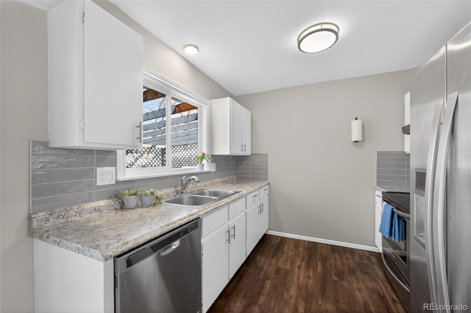 2116 Springfield Court Fort Collins, CO 80521 - Photo 21 of 29 a kitchen with a sink stove and refrigerator