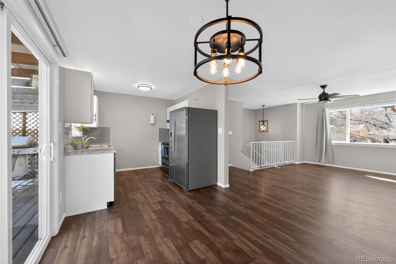 2116 Springfield Court Fort Collins, CO 80521 - Photo 22 of 29 a kitchen with wooden floor and a refrigerator