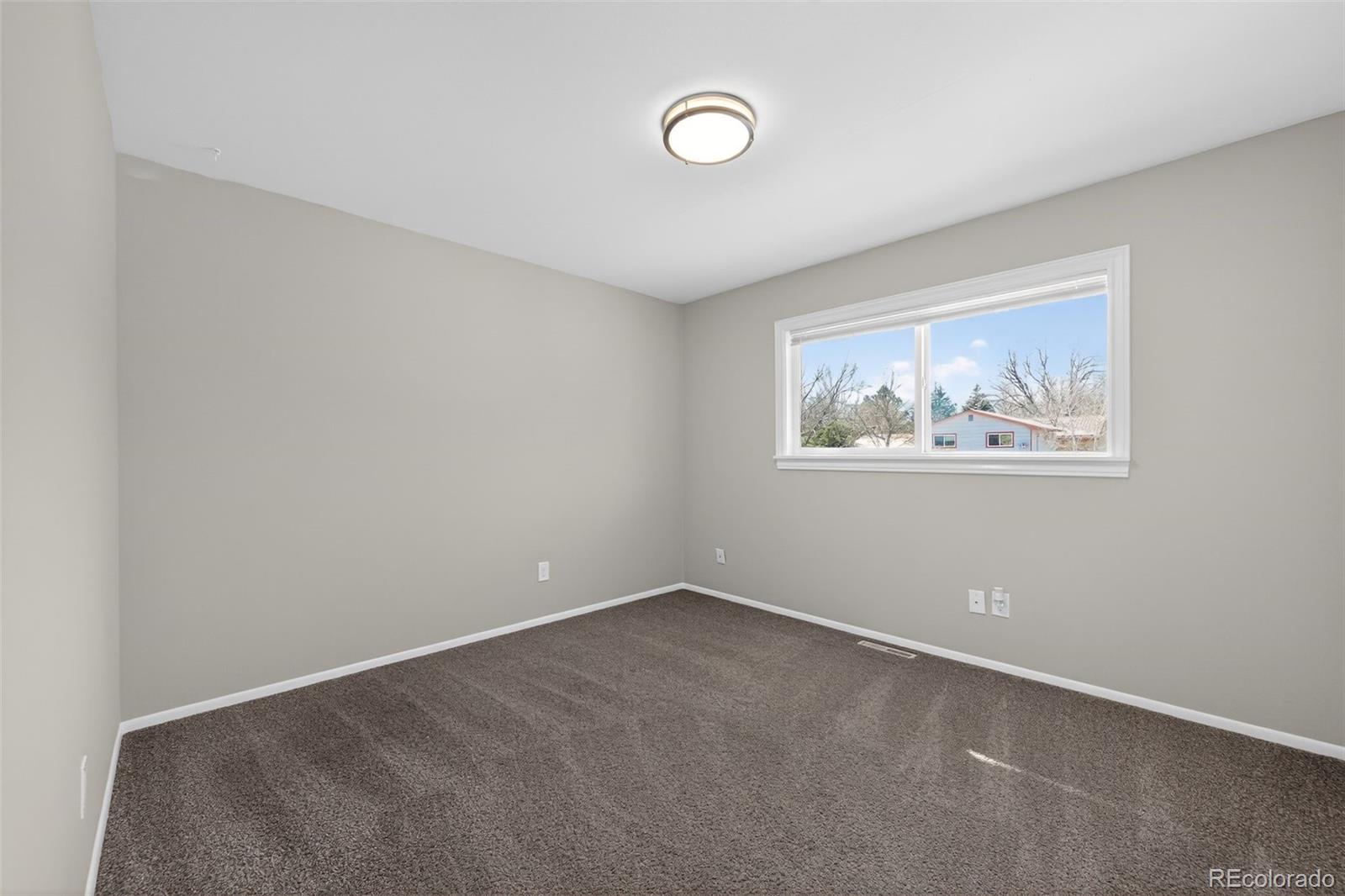2116 Springfield Court Fort Collins, CO 80521 - Photo 25 of 29 an empty room with a painting on the wall