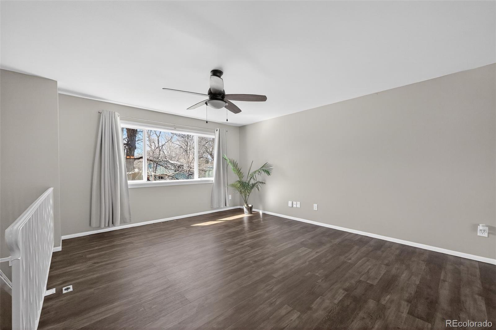 2116 Springfield Court Fort Collins, CO 80521 - Photo 27 of 29 a view of an empty room with wooden floor and a window
