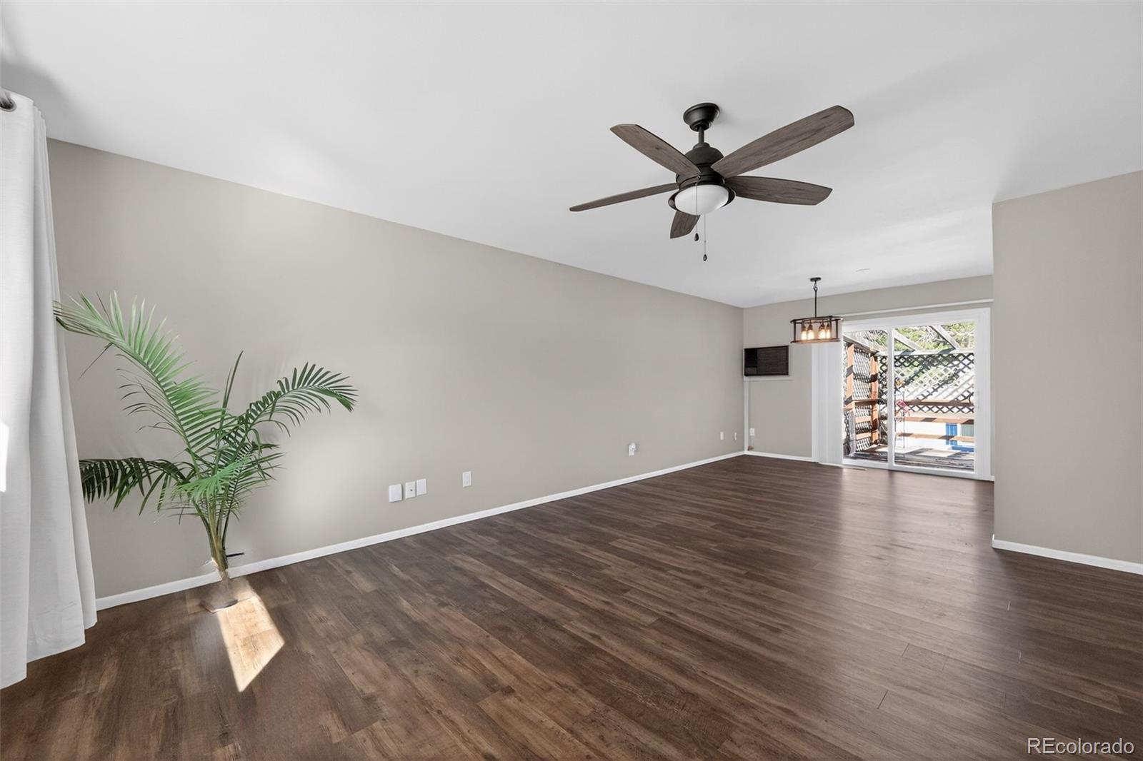 2116 Springfield Court Fort Collins, CO 80521 - Photo 29 of 29 a view of empty room with wooden floor and a ceiling fan