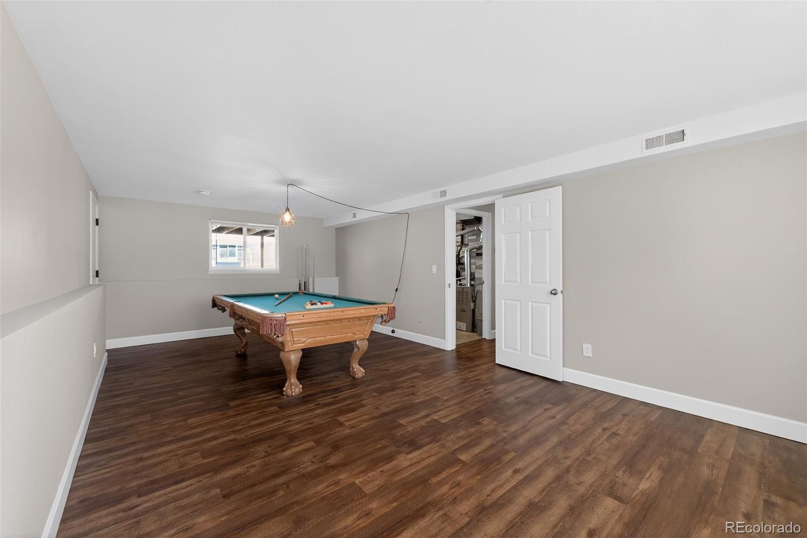 2116 Springfield Court Fort Collins, CO 80521 - Photo 7 of 29 a view of an empty room with wooden floor and a window