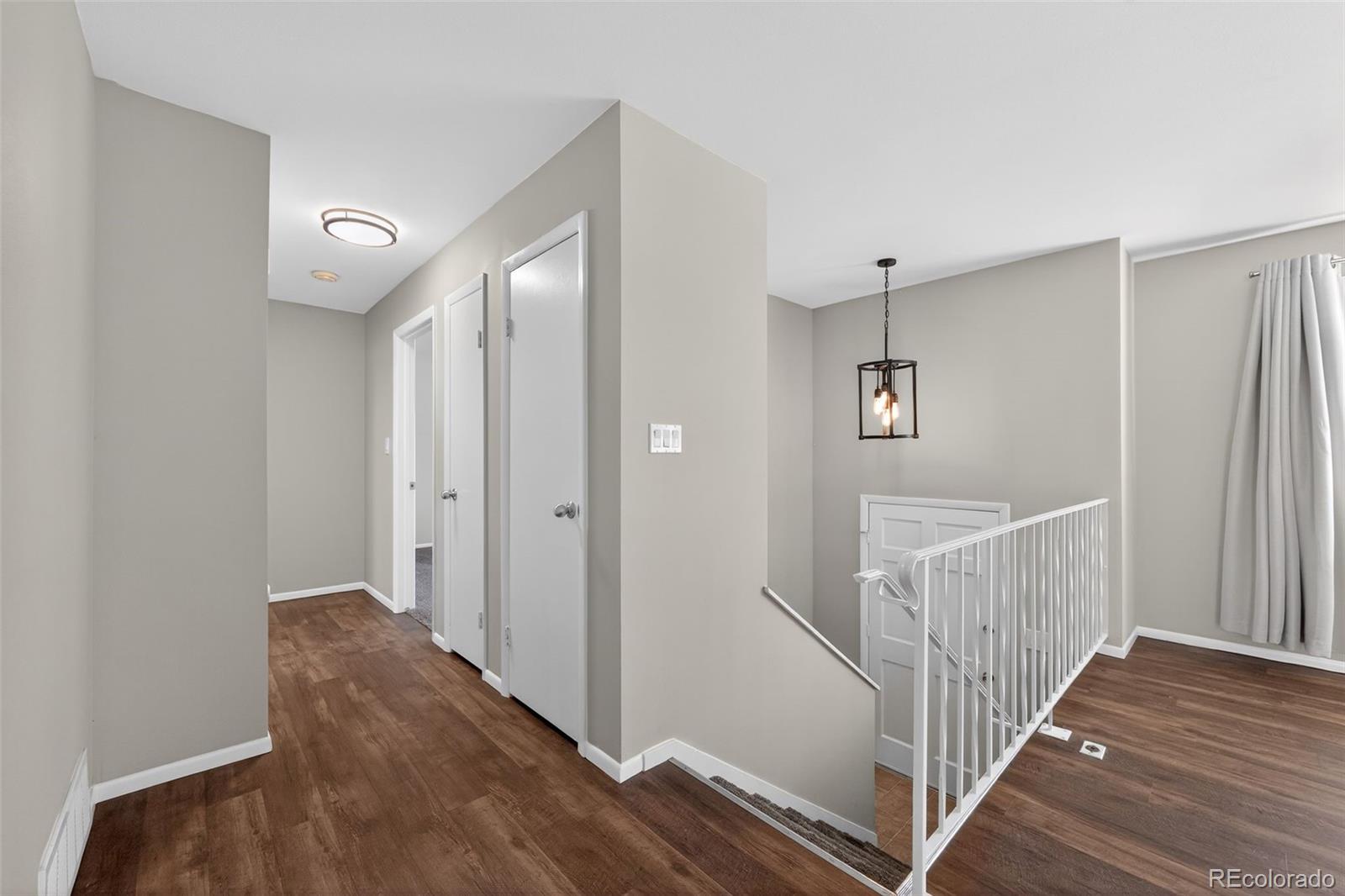 2116 Springfield Court Fort Collins, CO 80521 - Photo 9 of 29 a view of a hallway with entryway and wooden floor