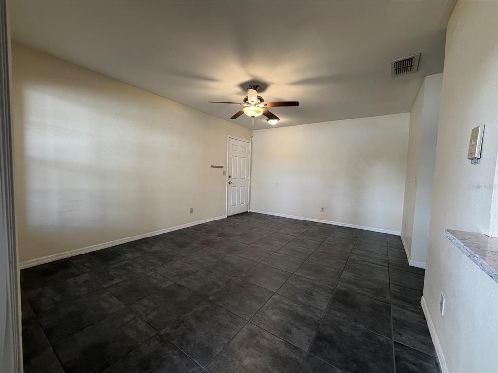1071 South Hiawassee Road, Unit 1214 Orlando, FL 32835 - Photo 3 of 17 an empty room with a ceiling fan and a window