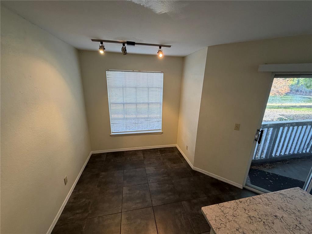 1071 South Hiawassee Road, Unit 1214 Orlando, FL 32835 - Photo 6 of 17 an empty room with wooden floor cabinet and windows