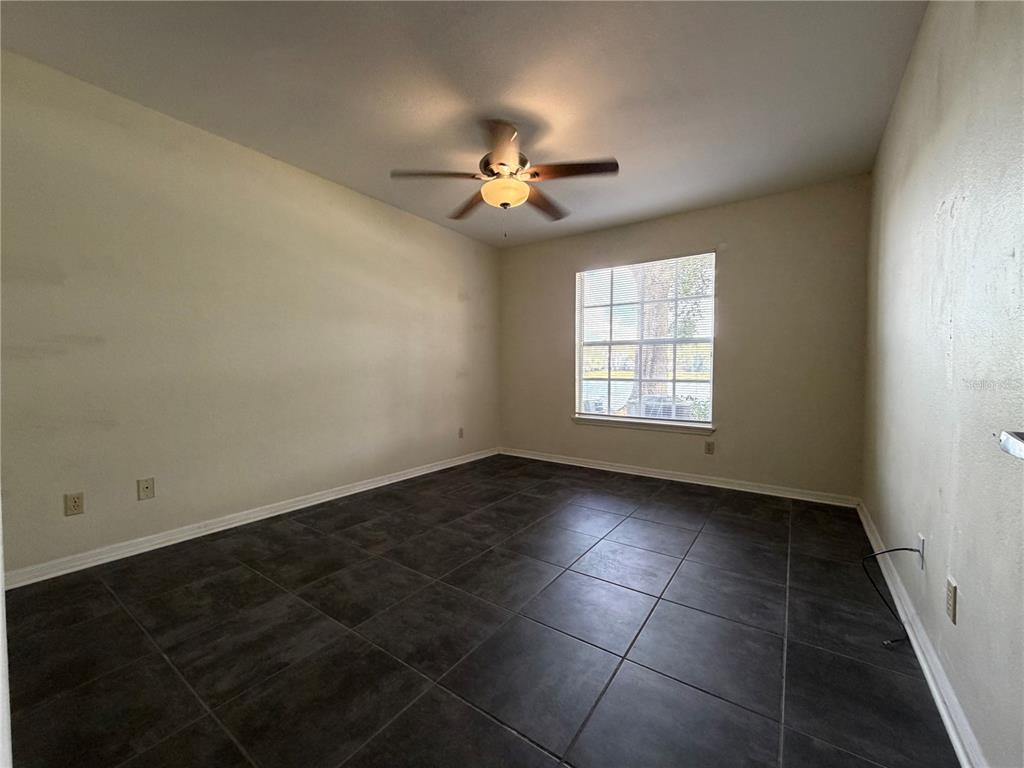1071 South Hiawassee Road, Unit 1214 Orlando, FL 32835 - Photo 7 of 17 an empty room with windows and fan