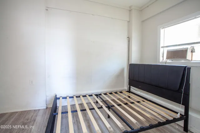 a view of an empty room with wooden floor