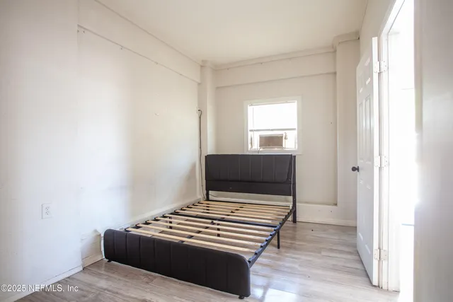 a bedroom with a bed and a window