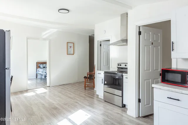 a kitchen with a refrigerator and a stove
