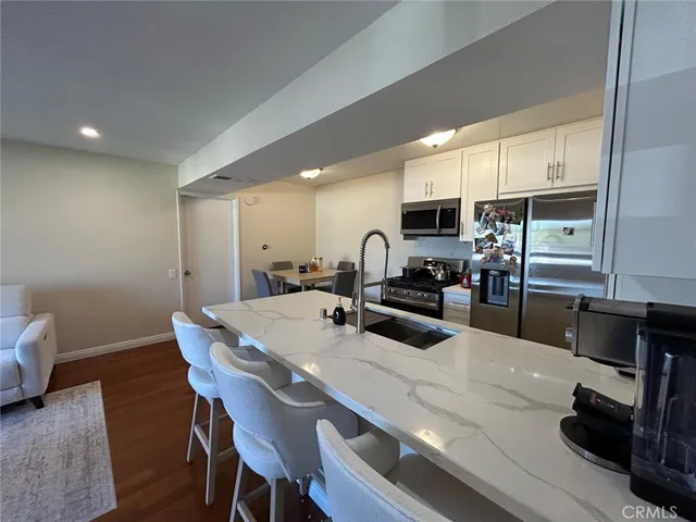 a kitchen with sink microwave and cabinets
