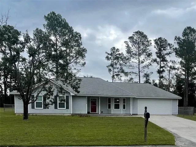 a front view of a house with a garden