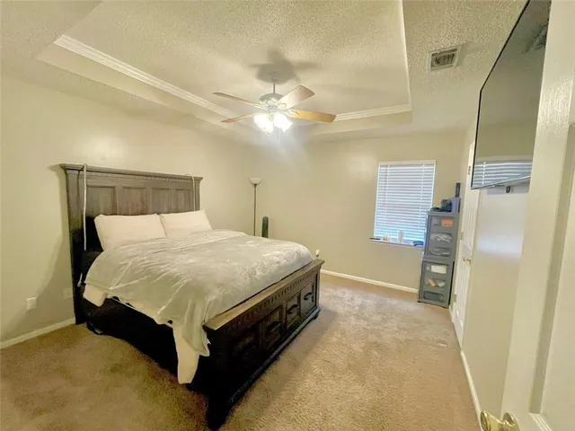 a spacious bedroom with a bed and a walk in closet