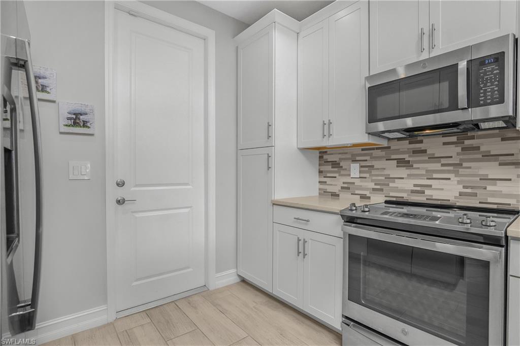 7588 Morgan Way Naples, FL 34119 - Photo 8 of 42 Kitchen includes Stainless Steel appliances