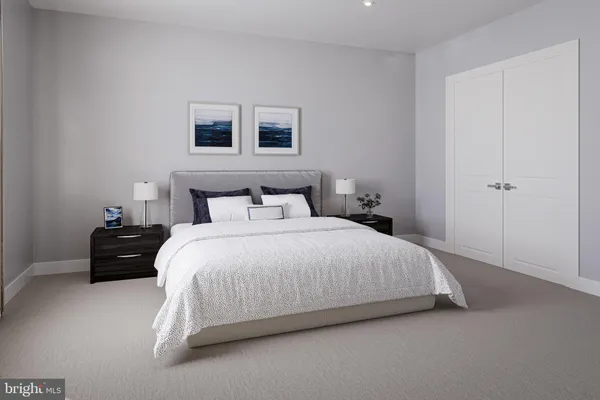 a bedroom with a bed and a night stand