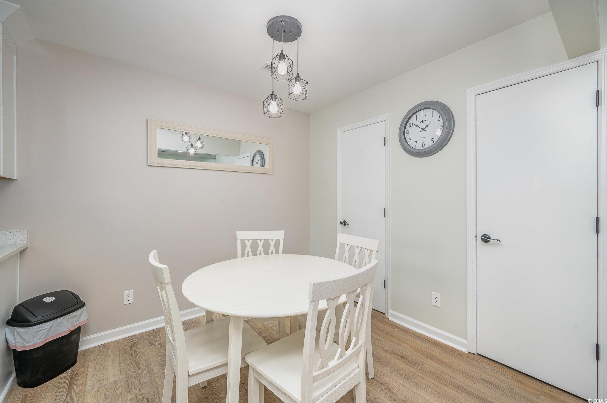 412 27th Avenue North Myrtle Beach, SC 29577 - Photo 10 of 35 Dining room featuring light wood-style flooring and baseboards