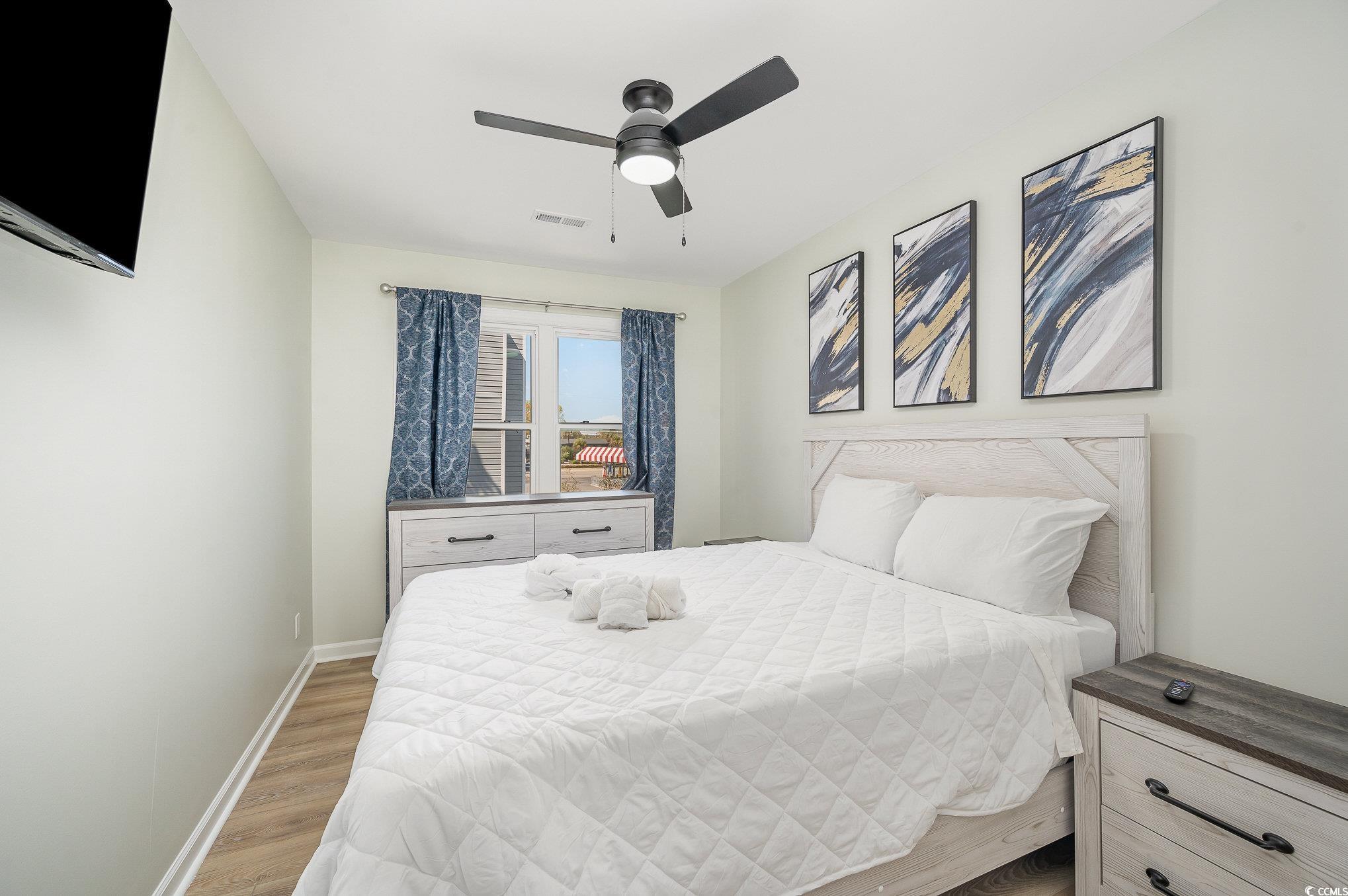 412 27th Avenue North Myrtle Beach, SC 29577 - Photo 15 of 35 Bedroom with wood finished floors and a ceiling fan