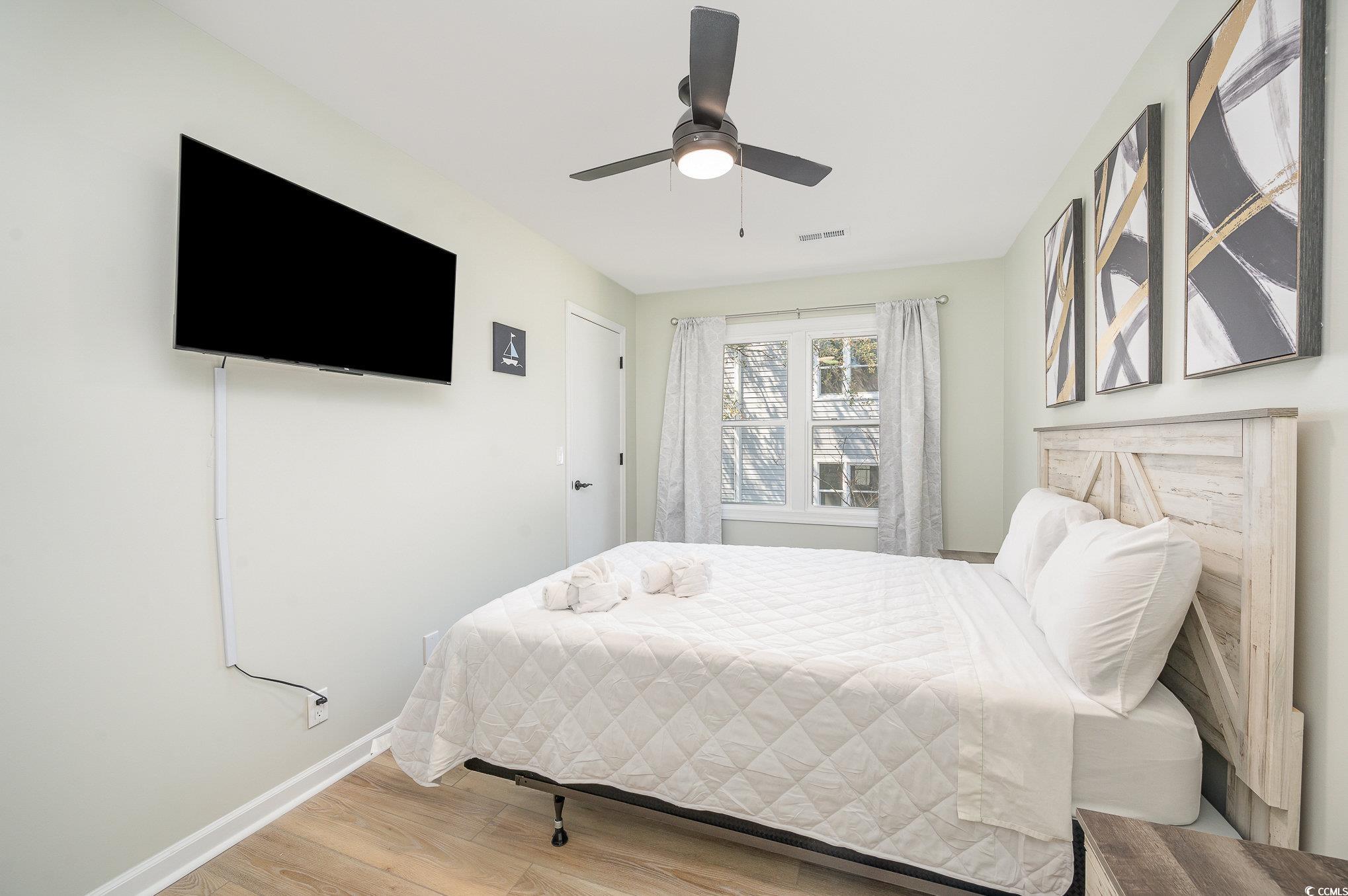 412 27th Avenue North Myrtle Beach, SC 29577 - Photo 16 of 35 Bedroom featuring light wood-style flooring and ceiling fan