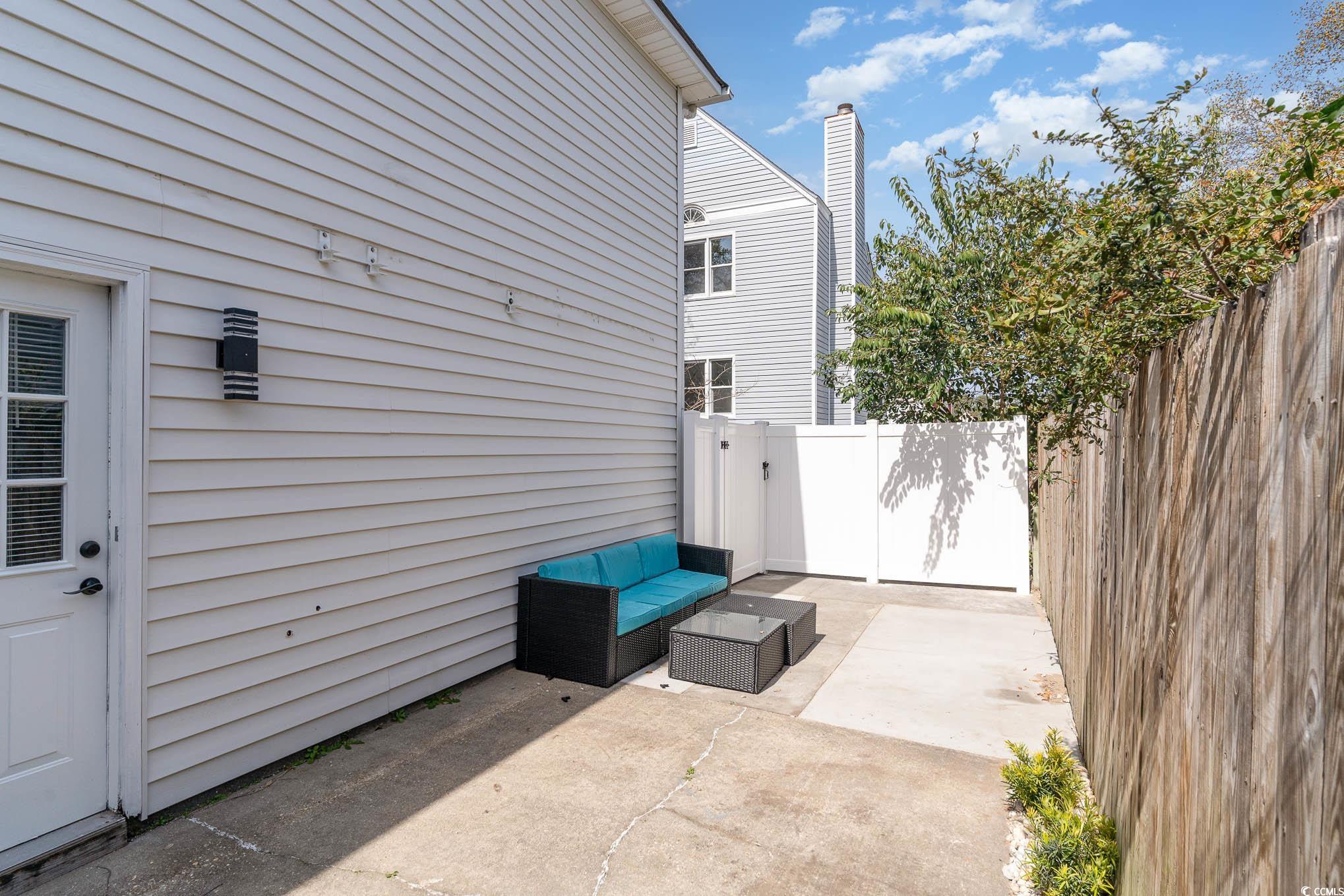 412 27th Avenue North Myrtle Beach, SC 29577 - Photo 21 of 35 Fenced backyard with a patio and outdoor lounge area