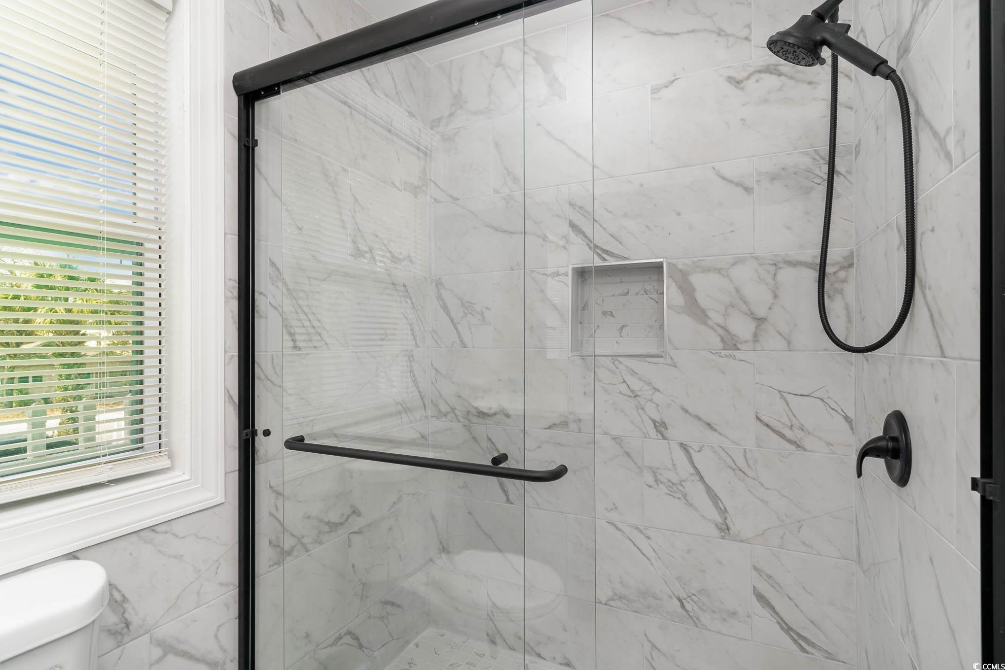 412 27th Avenue North Myrtle Beach, SC 29577 - Photo 22 of 35 Bathroom with a marble finish shower